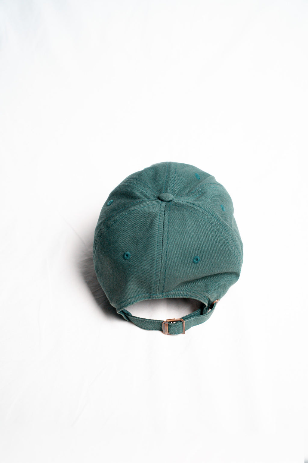 FOA green cap, rear view showing the adjustable strap and buckle.