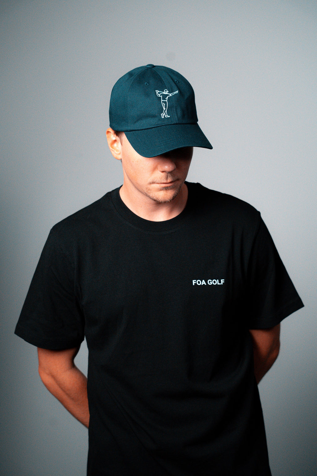 FOA navy cap, worn on a model.