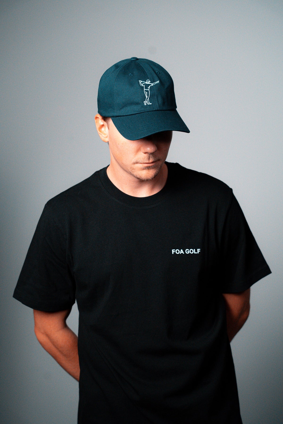 FOA navy cap, worn on a model.