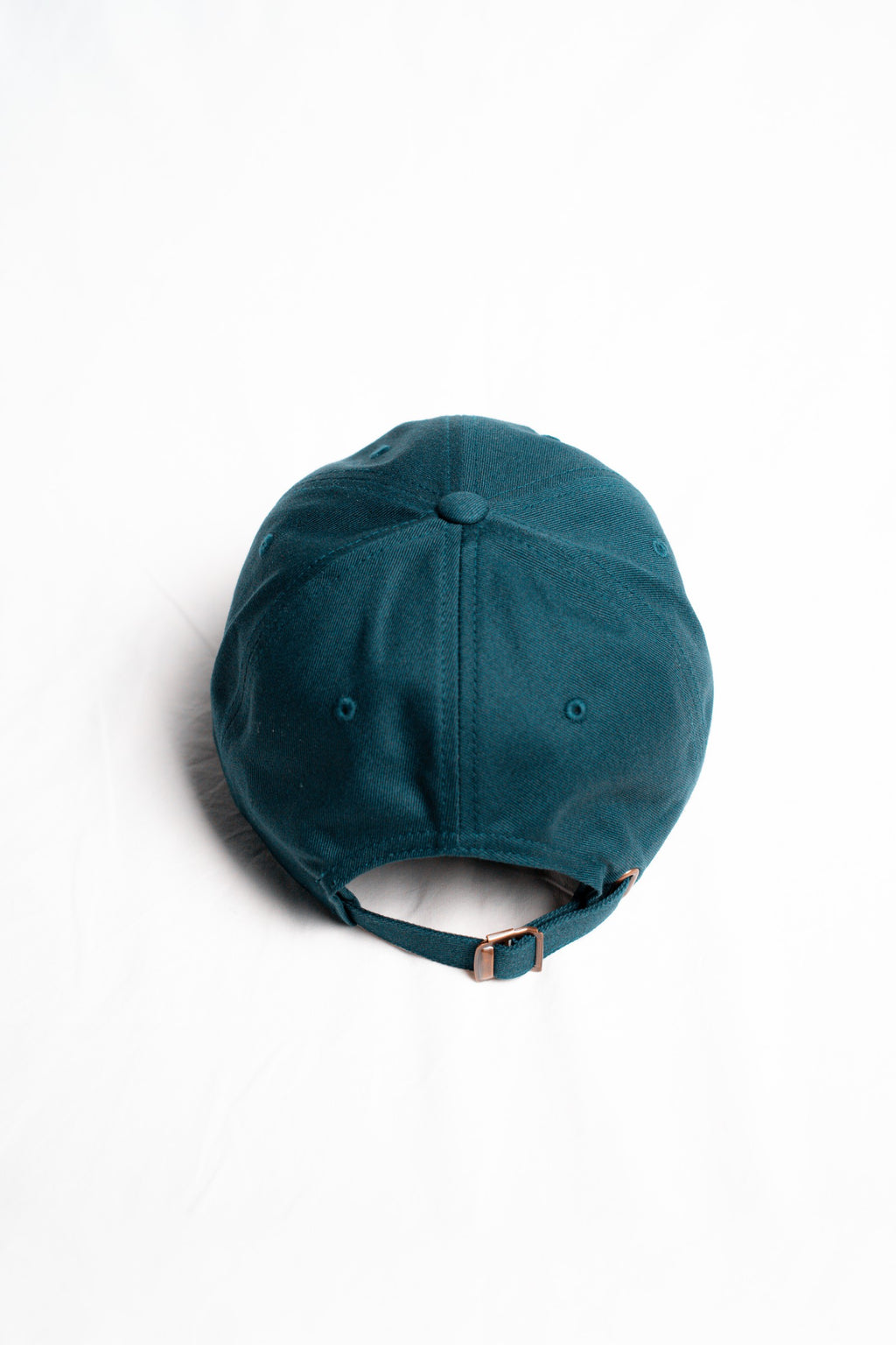 FOA navy cap, rear view showing the adjustable strap and buckle.