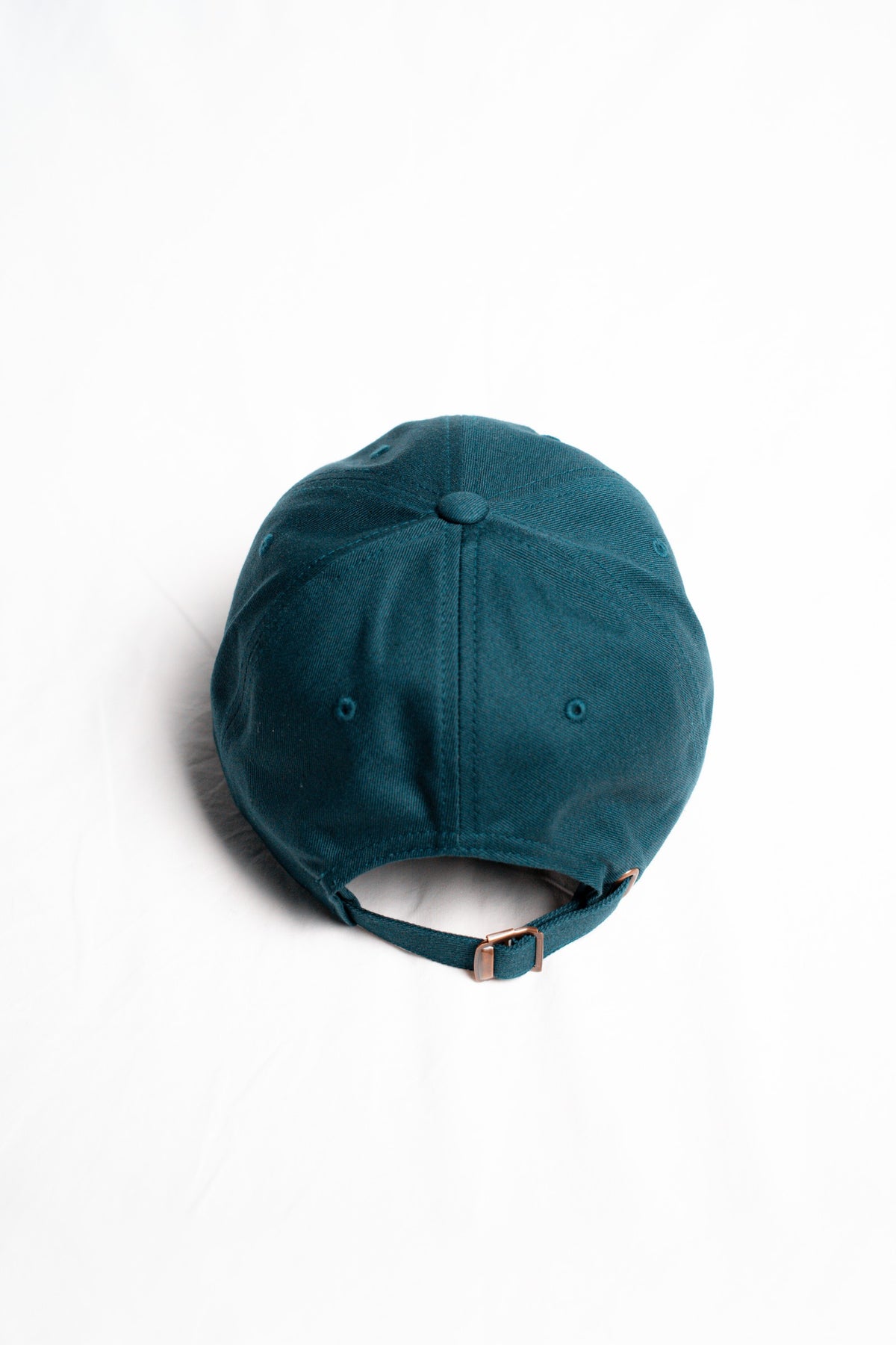 FOA navy cap, rear view showing the adjustable strap and buckle.