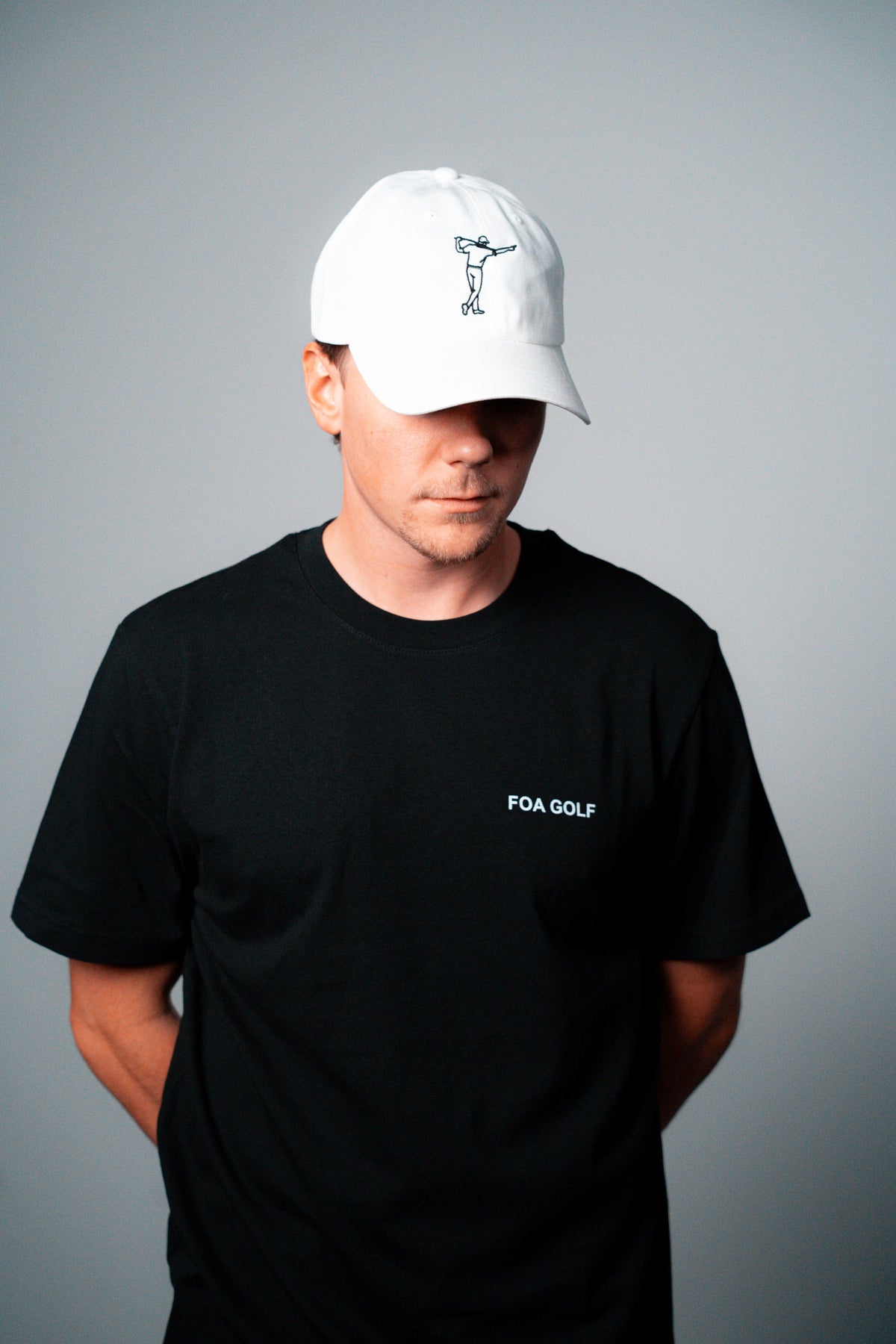 FOA white cap, worn on a model.