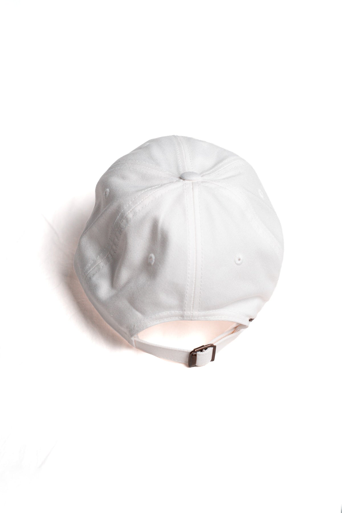 FOA white cap, rear view showing the adjustable strap and buckle.