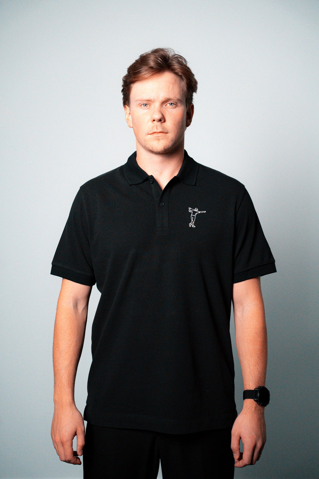 FOA black polo, front view worn on a model.