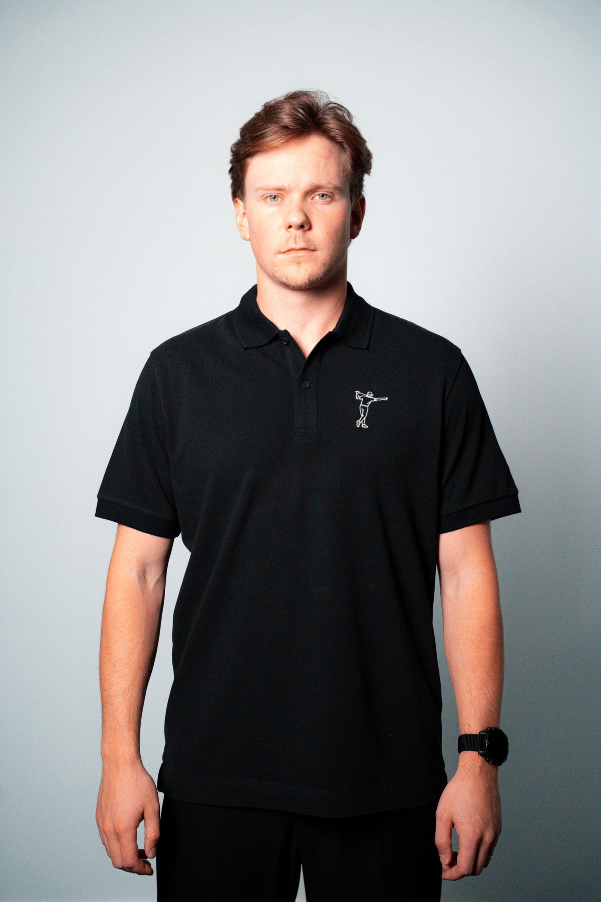 FOA black polo, front view worn on a model.