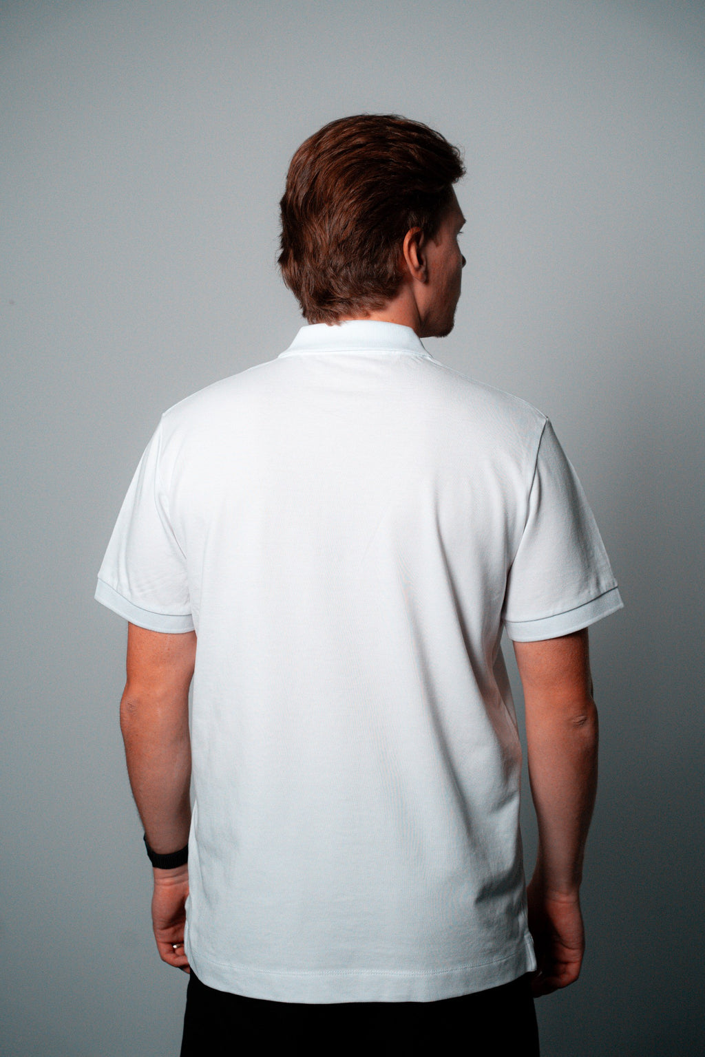 FOA white polo, back view worn on a model.