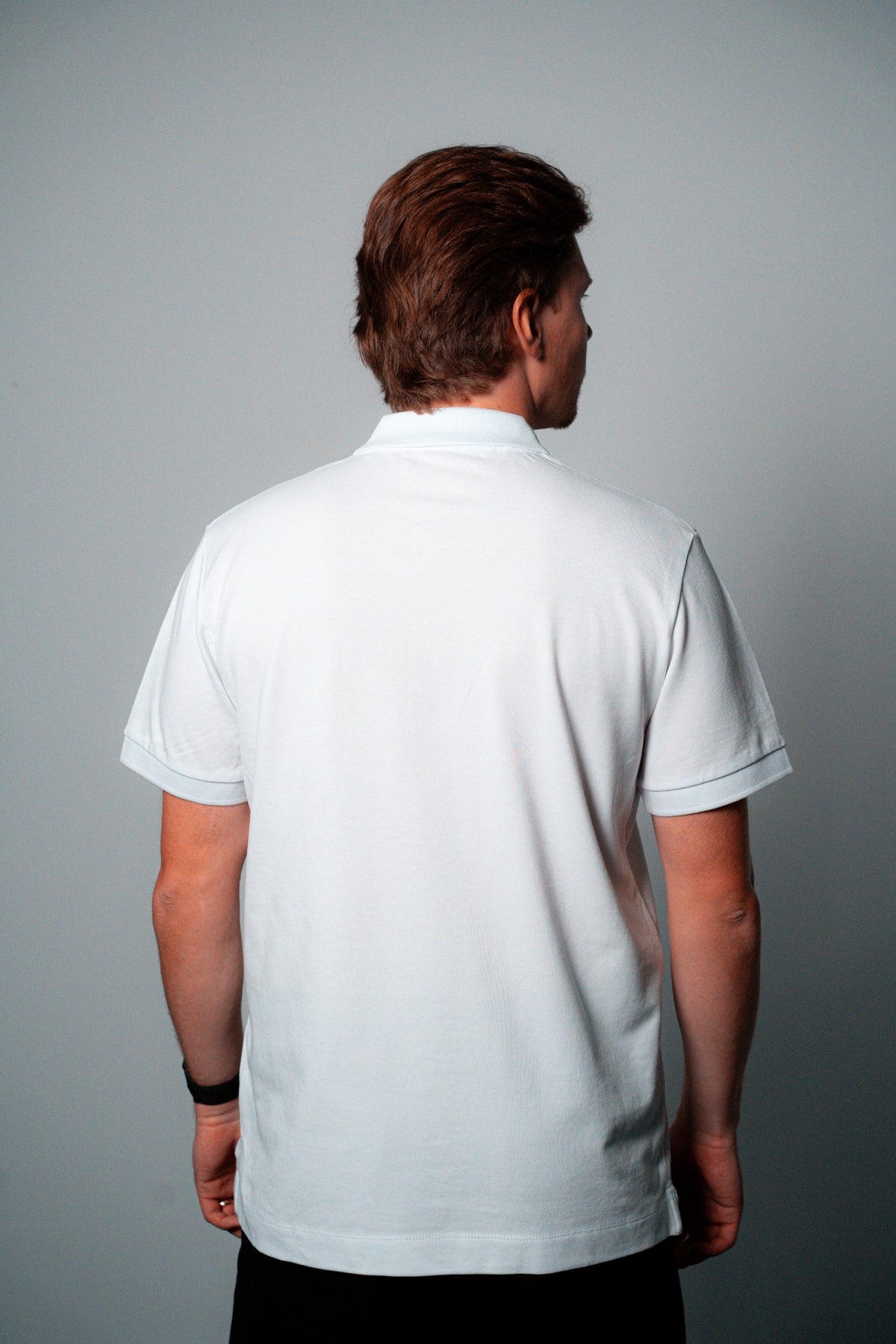 FOA white polo, back view worn on a model.