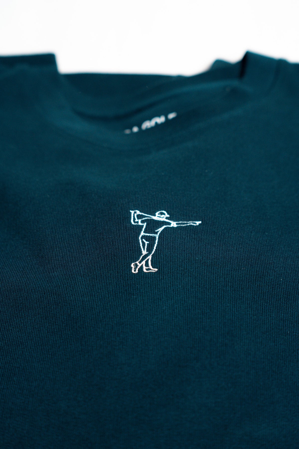 FOA navy sweatshirt, close-up of the embroidered golfer and fabric.