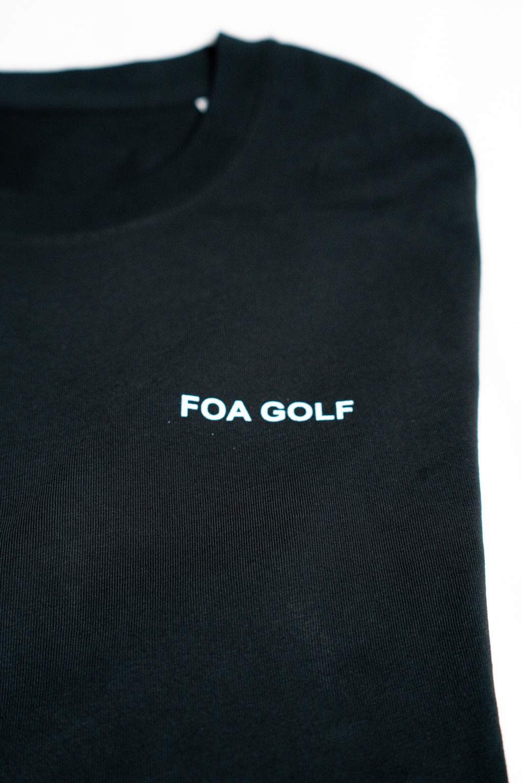 FOA black t-shirt, close-up of the FOA GOLF chest print.