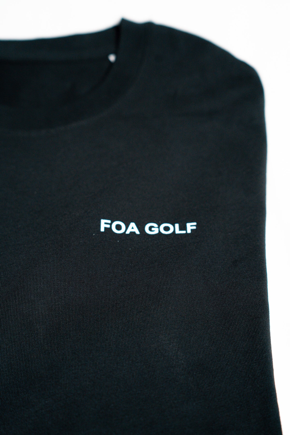 FOA black t-shirt, close-up of the FOA GOLF chest print.