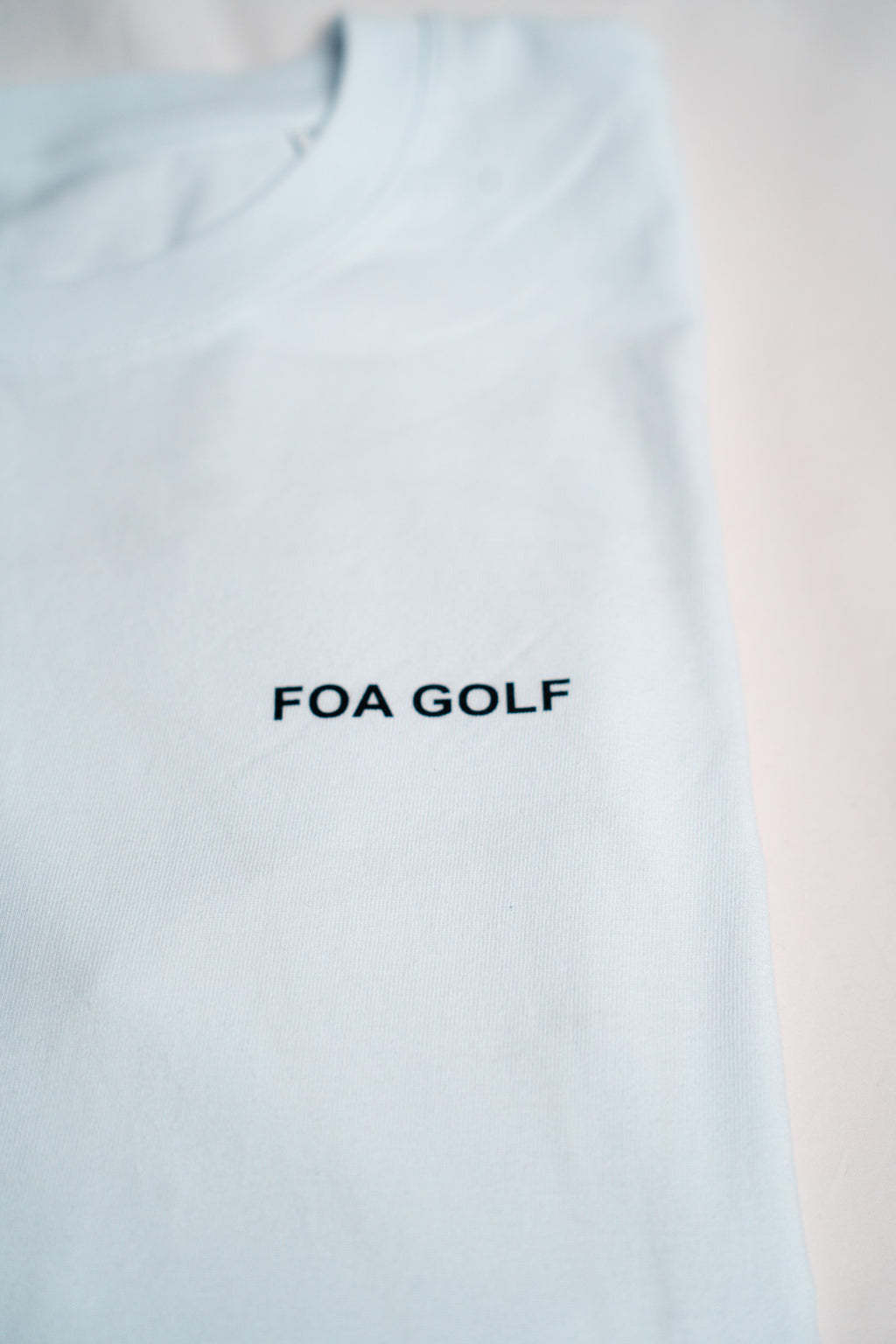FOA white t-shirt, close-up of the FOA GOLF chest print.