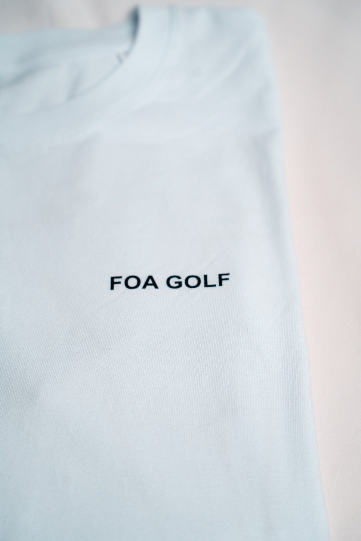 FOA white t-shirt, close-up of the FOA GOLF chest print.